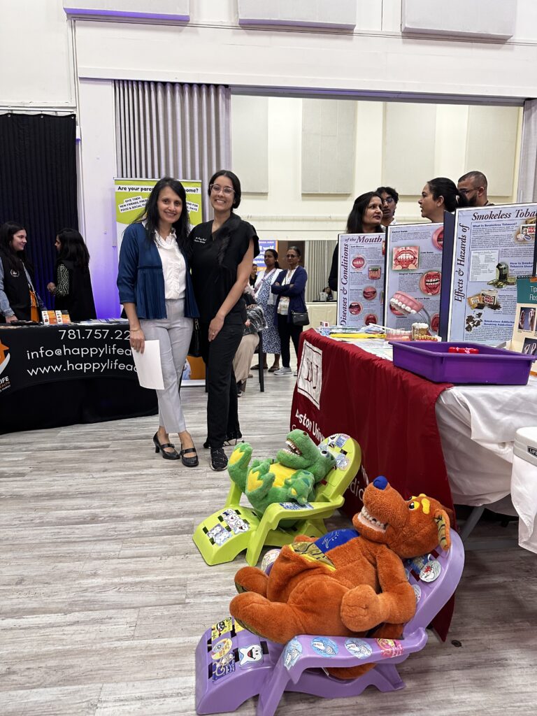 Commissioner Vaishali Gade and a community representative smile for the camera in the middle of the Senior Wellness Expo