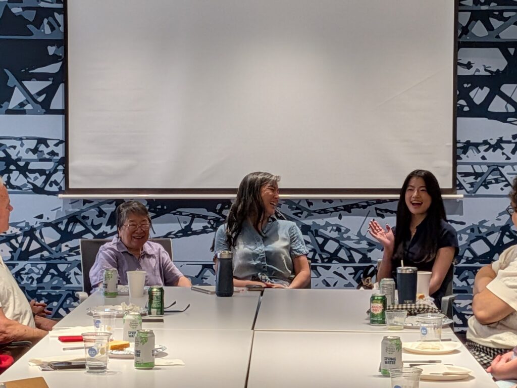Panelists Marie Enochty (left), Erica Tso Haidas, co-creator of Unerased film (center), and Josie Sigel (right) lead a discussion, with Josie speaking and other panelists looking at her, smiling