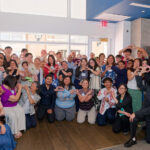 FY26 Small Grants Awardees Display Hearts While Smiling for the Camera