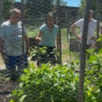 Community members admire a garden while chatting about wellness