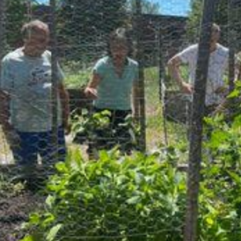 Community members admire a garden while chatting about wellness