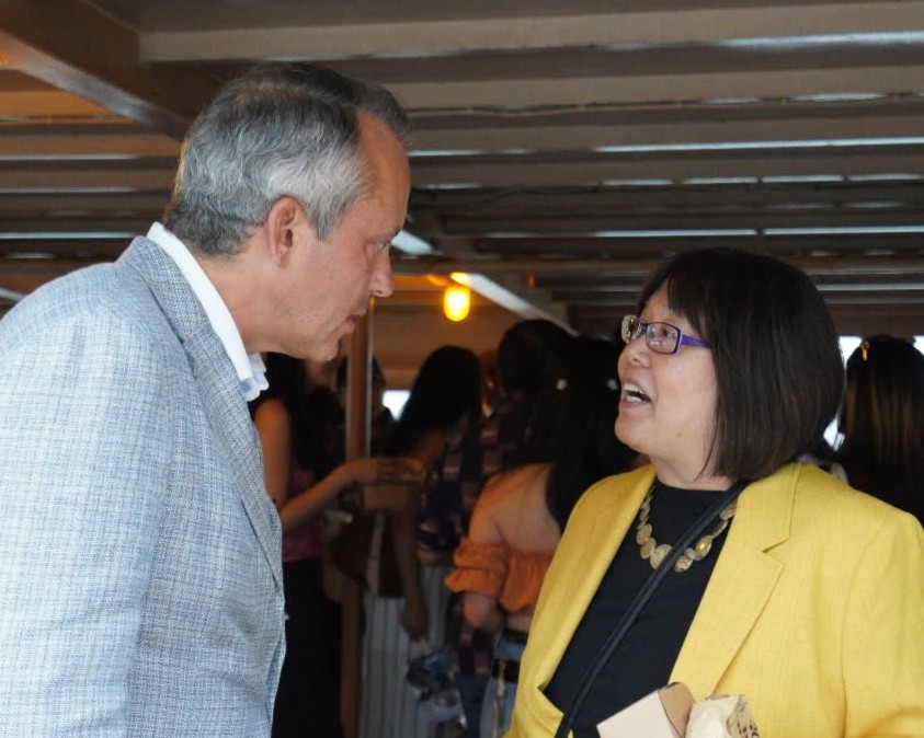 Representative Aaron Michlewitz is deep in conversation with Executive Director Amihan Matias